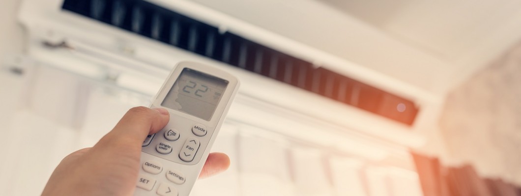 How does the universal IR adapter for air conditioning control work?